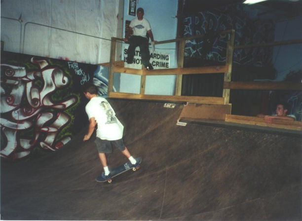 Griffin working the mini-ramp as Peter K. looks on