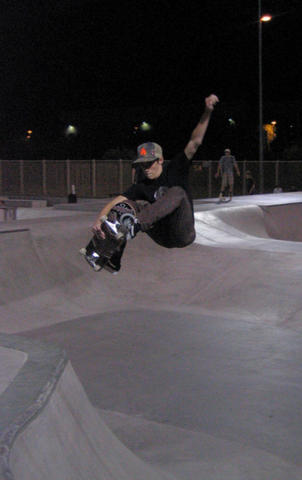 local Tempe Skatepark ripper, Riley, floats a frontside hip ollie grab