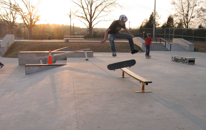 Local Scott kickflips over the gap and bench