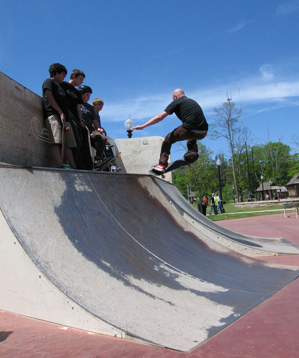 Peter tranfers over the hip with a nice ollie as the kids look on