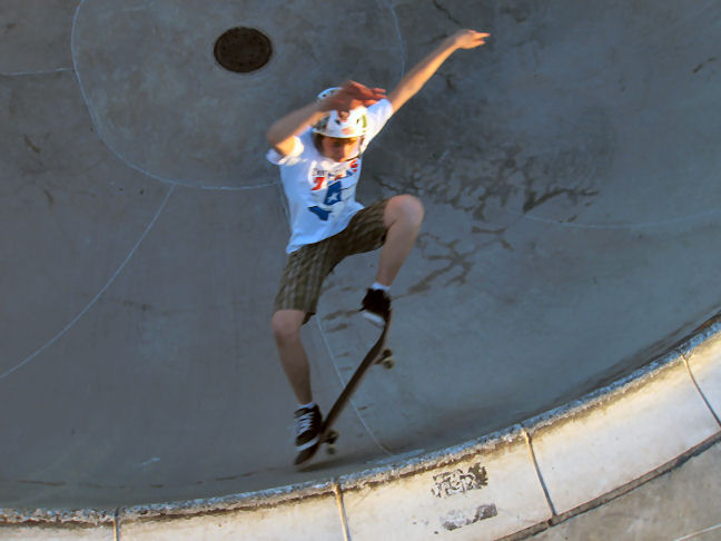 Scott Lolley popping frontside ollies at tile and padless in the deep end
